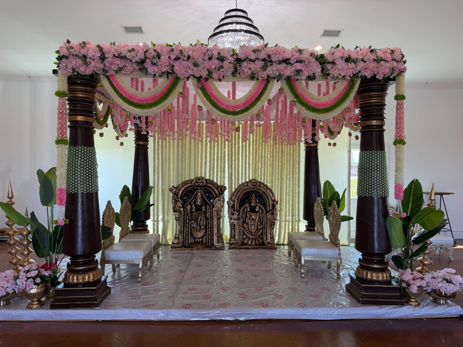 Wedding Mandap with Pink Garlands and Deity Idols